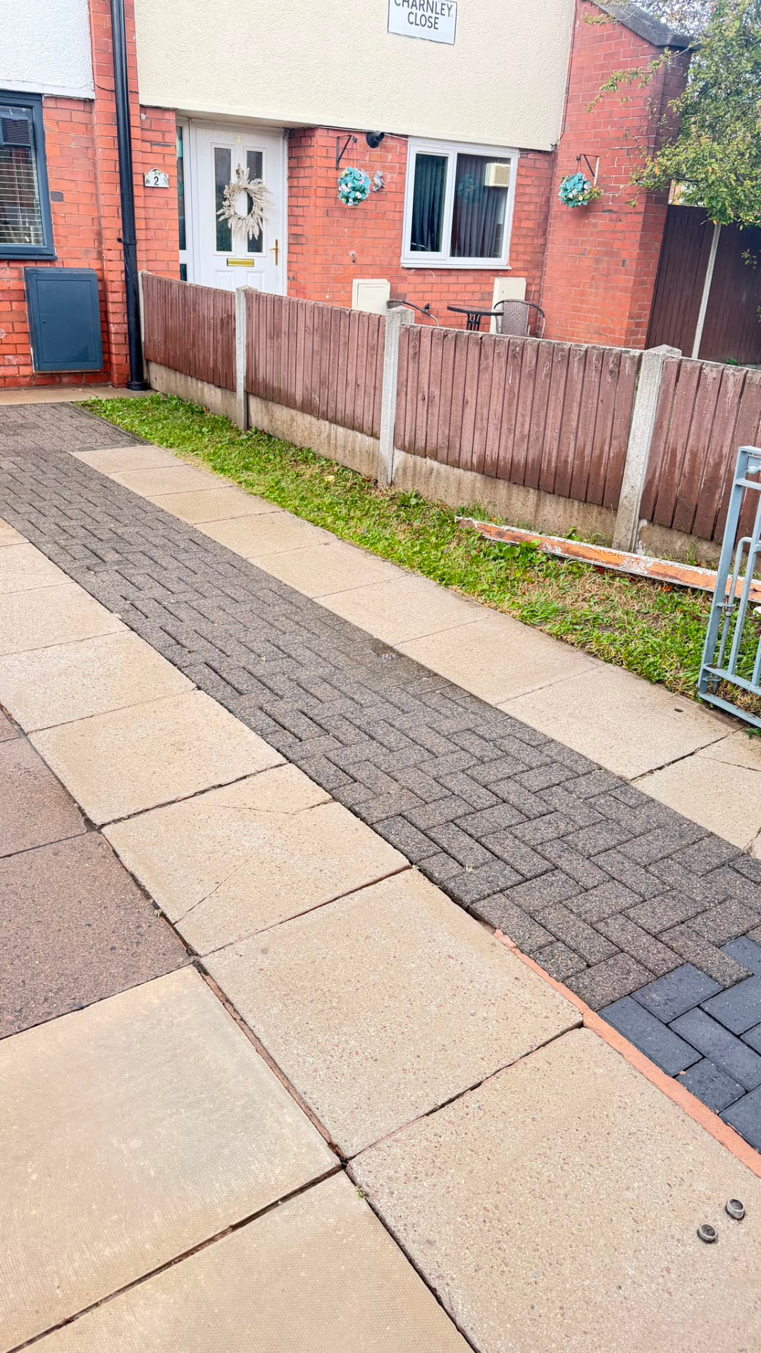 Cleaned paving slabs leading to a Manchester front door