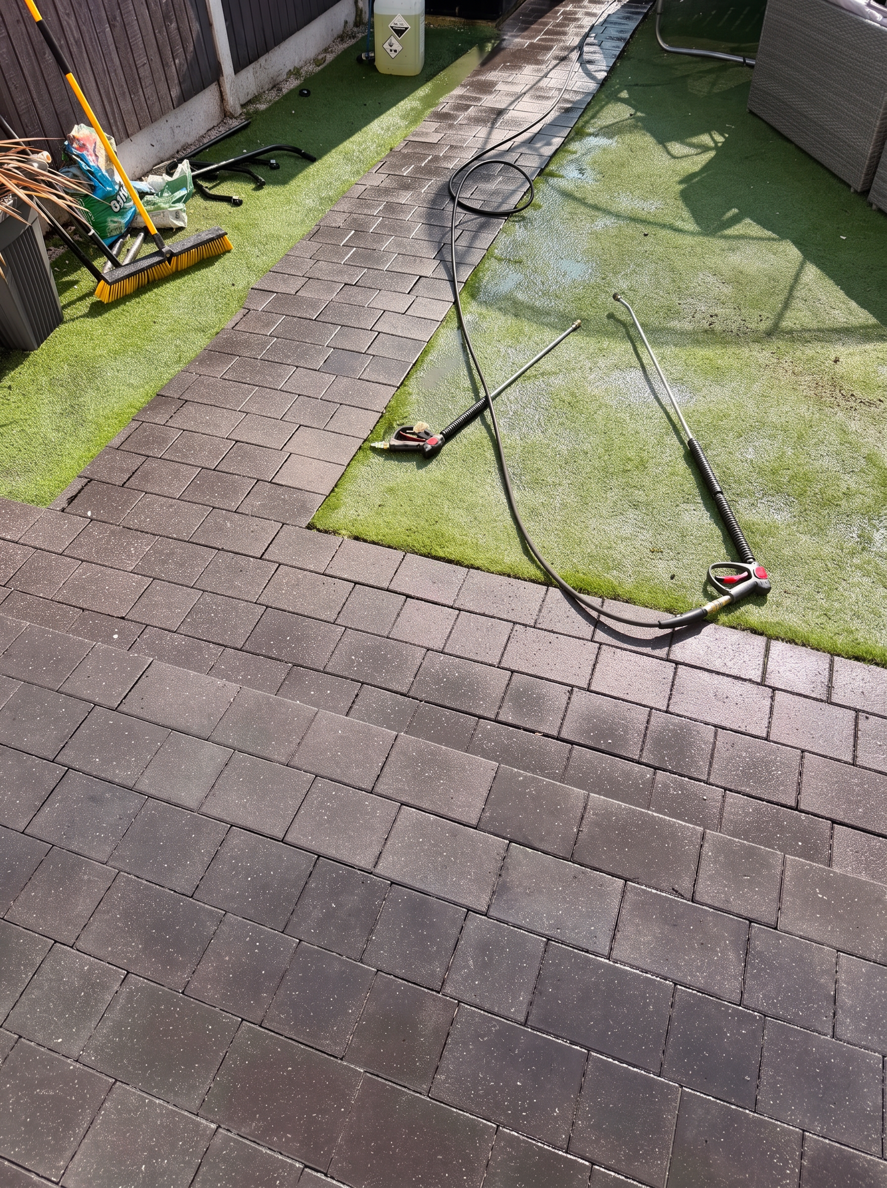 The same block paved garden path after professional pressure washing, weeds gone and paving clean