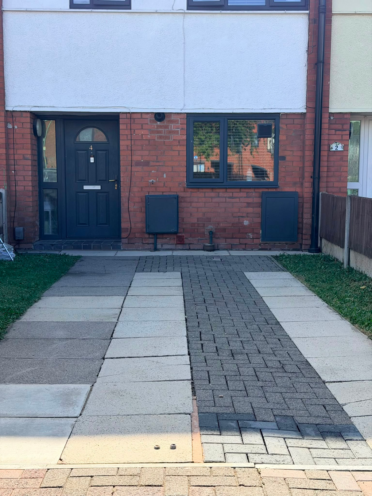 The same driveway after professional pressure cleaning, paving clean and even