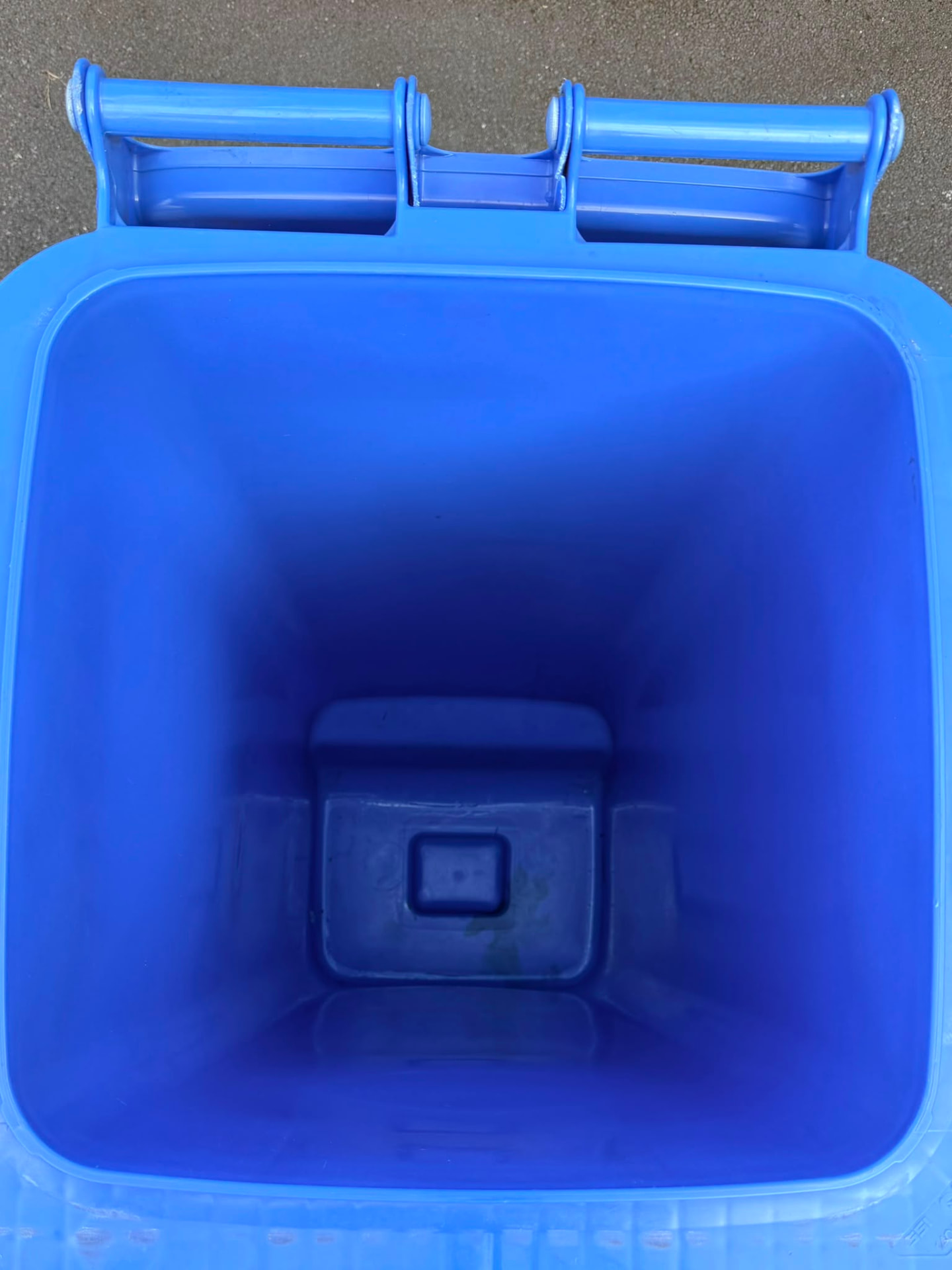 The same blue recycling wheelie bin after professional cleaning, spotless inside